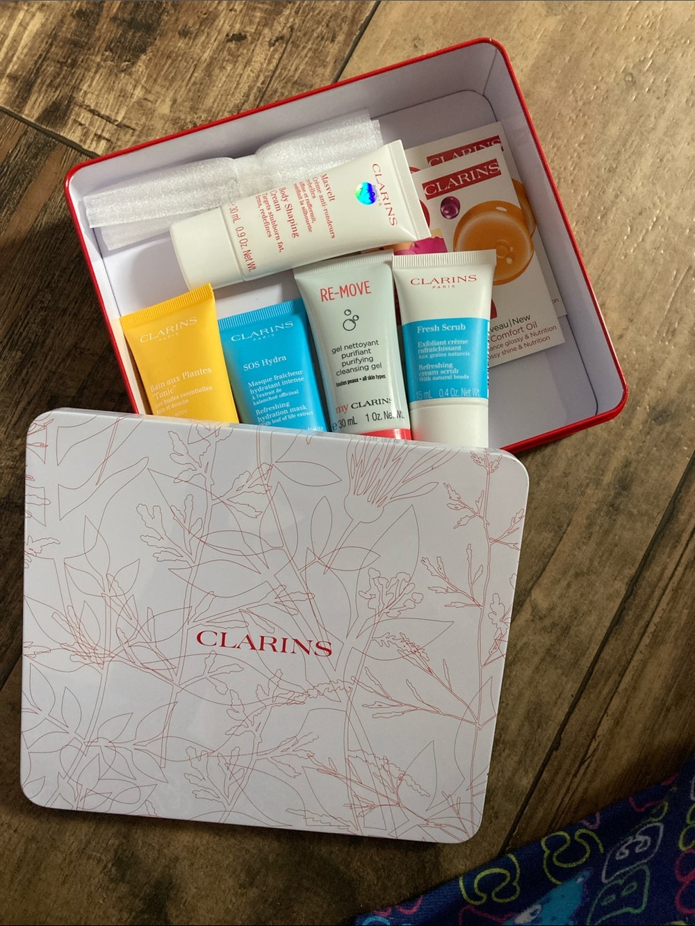 Clarins Mini Skincare Tin with White, Yellow, Blue & Coral Tubes